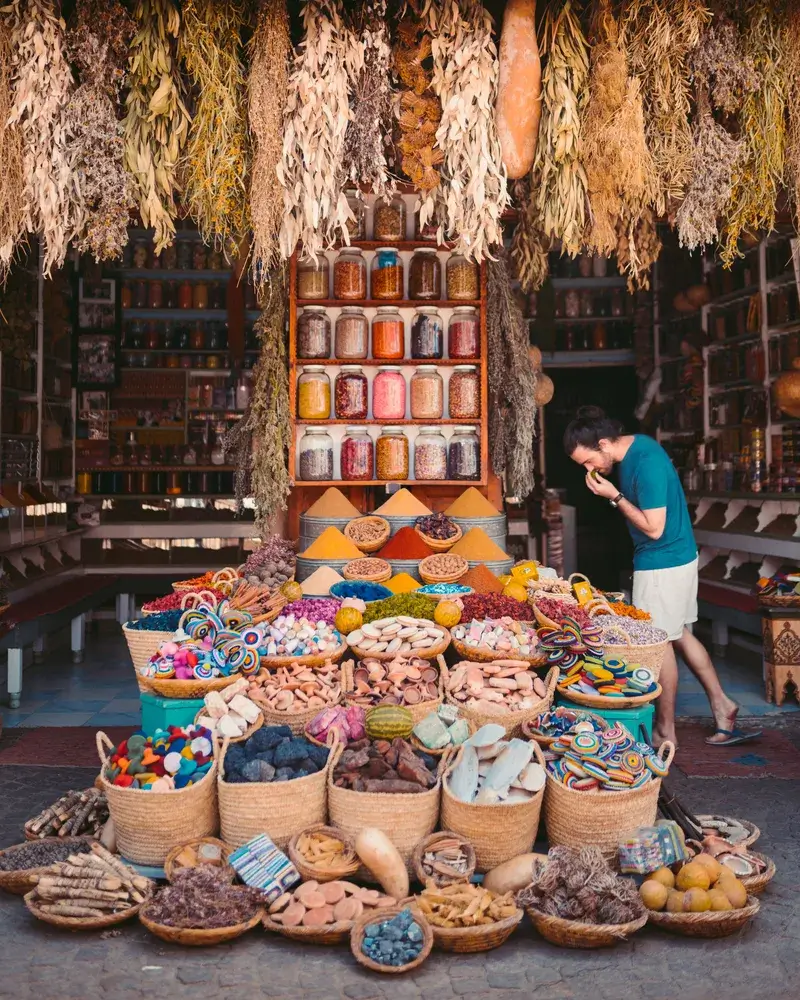 Tourist exploring a vibrant spice market and traditional souk | Proper Morocco Tours